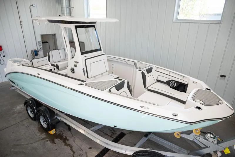 Slide: The Image of 2024 Yamaha Boats 252 FSH Sport in a garage, on a trailer, side view. - 9