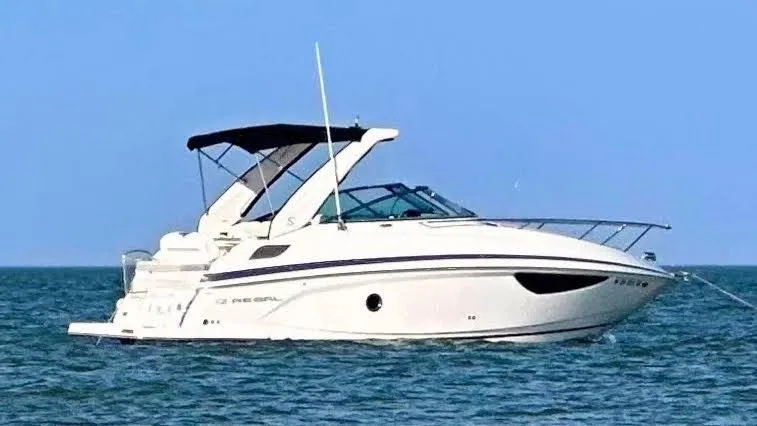 Slide: The Image of 2021 Regal 28 Express boat on calm blue water. - 10