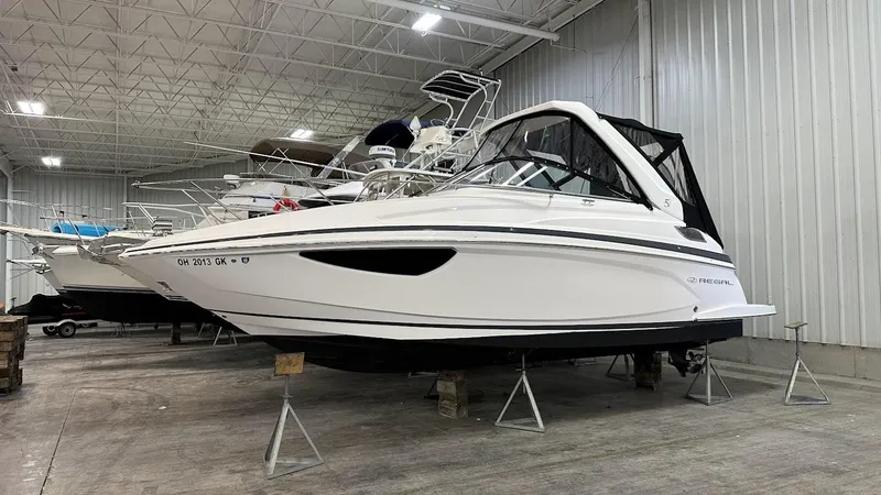 Slide: The Image of 2021 Regal 28 Express boat in storage facility. - 11