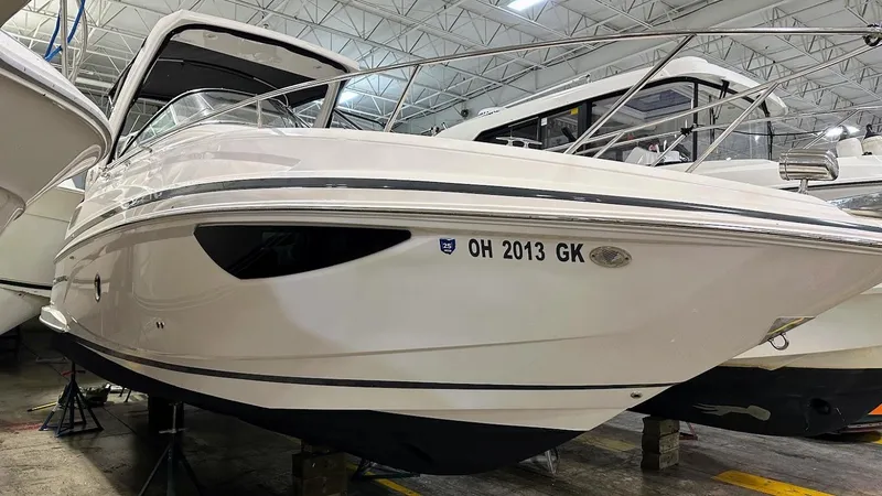 Slide: The Image of 2021 Regal 28 Express boat in indoor storage facility. - 12