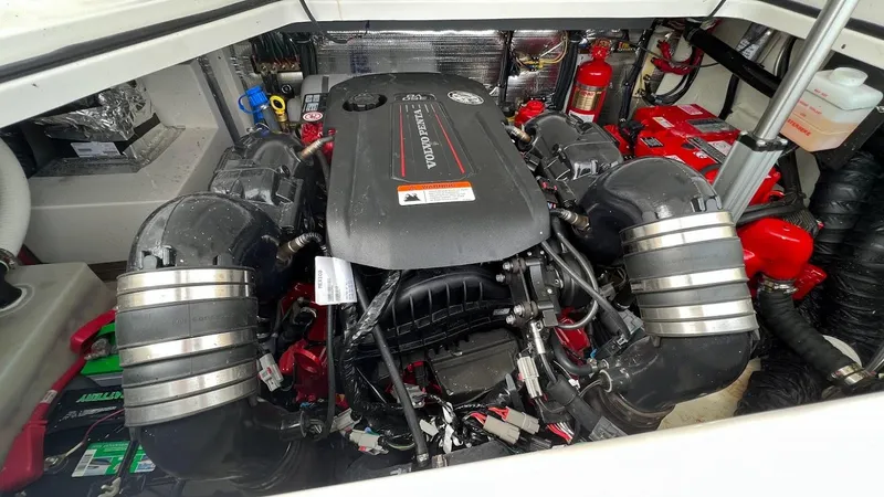 Slide: The Image of 2021 Regal 28 Express engine compartment with dual batteries and fire extinguisher. - 13