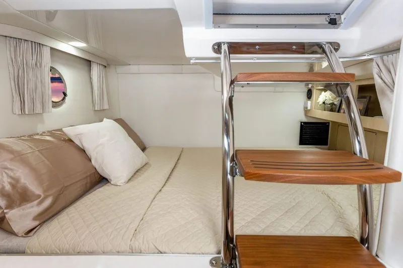 Slide: The Image of 2021 Regal 28 Express cabin interior with bed and wooden steps. - 5