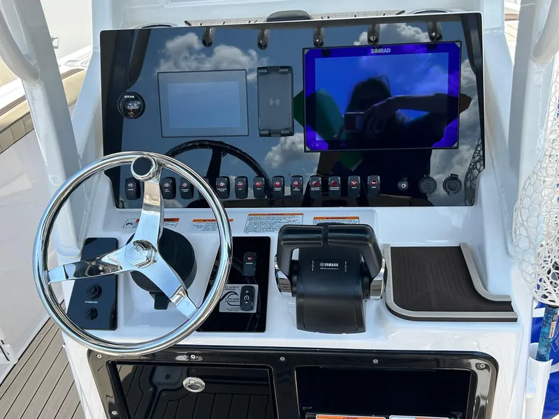 Slide: The Image of 2024 Yamaha Boats 252 FSH Sport dashboard with steering wheel and control panel. - 4