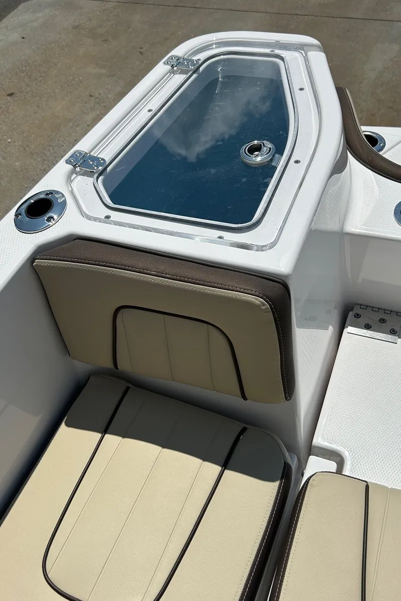 Slide: The Image of 2024 Yamaha Boats 252 FSH Sport interior seating and storage compartment. - 9