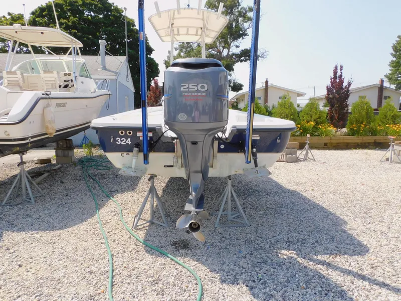 Slide: The Image of 2009 Ranger 2200 Bay Ranger boat on stands, gravel lot, outboard motor visible. - 10