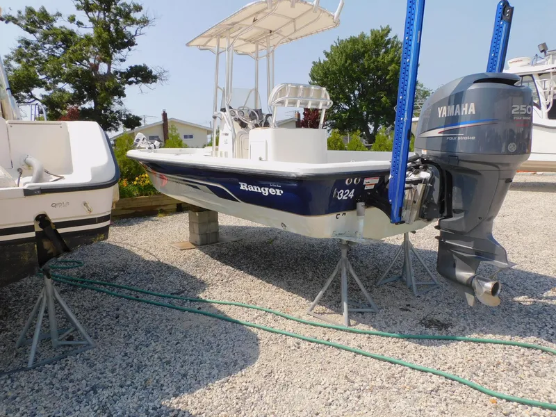 Slide: The Image of 2009 Ranger 2200 Bay Ranger boat with Yamaha 250 engine on gravel. - 11