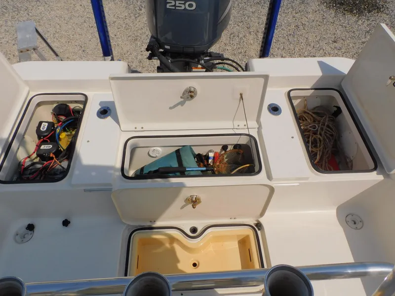 Slide: The Image of 2009 Ranger 2200 Bay Ranger boat storage compartments with engine and equipment visible. - 18