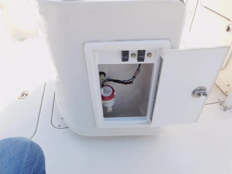 Slide: The Image of Open compartment on 2009 Ranger 2200 Bay Ranger boat showing wiring and switches. - 22