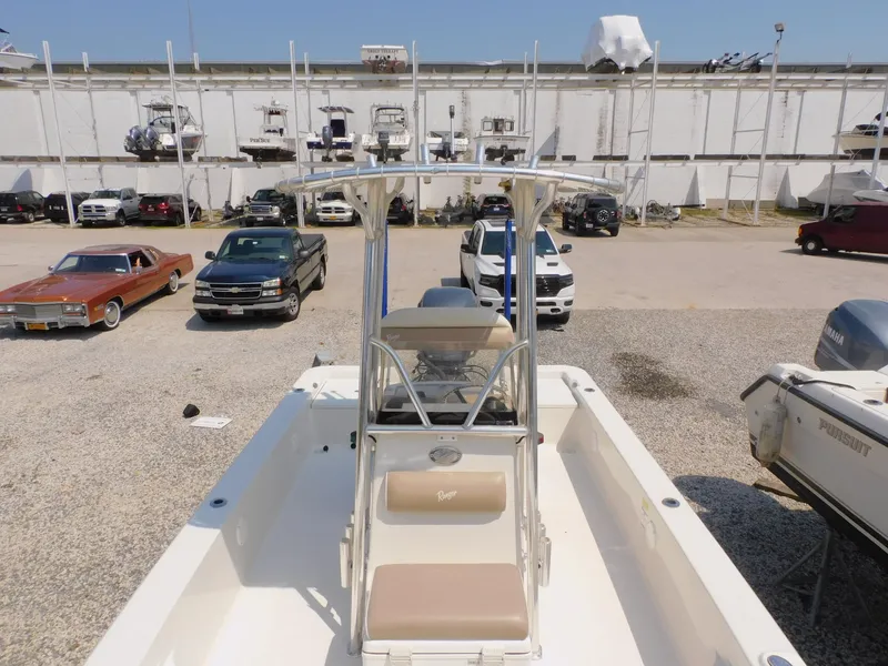 Slide: The Image of 2009 Ranger 2200 Bay Ranger boat in a marina with parked cars and boats. - 27