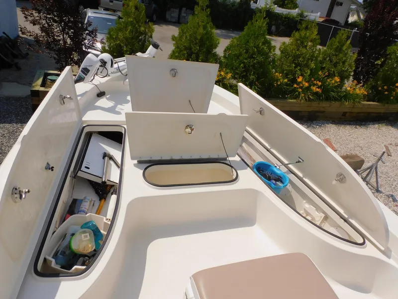 Slide: The Image of 2009 Ranger 2200 Bay Ranger boat with open storage compartments and fishing gear. - 29