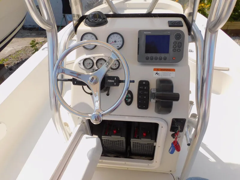 Slide: The Image of 2009 Ranger 2200 Bay Ranger boat console with steering wheel and navigation controls. - 32
