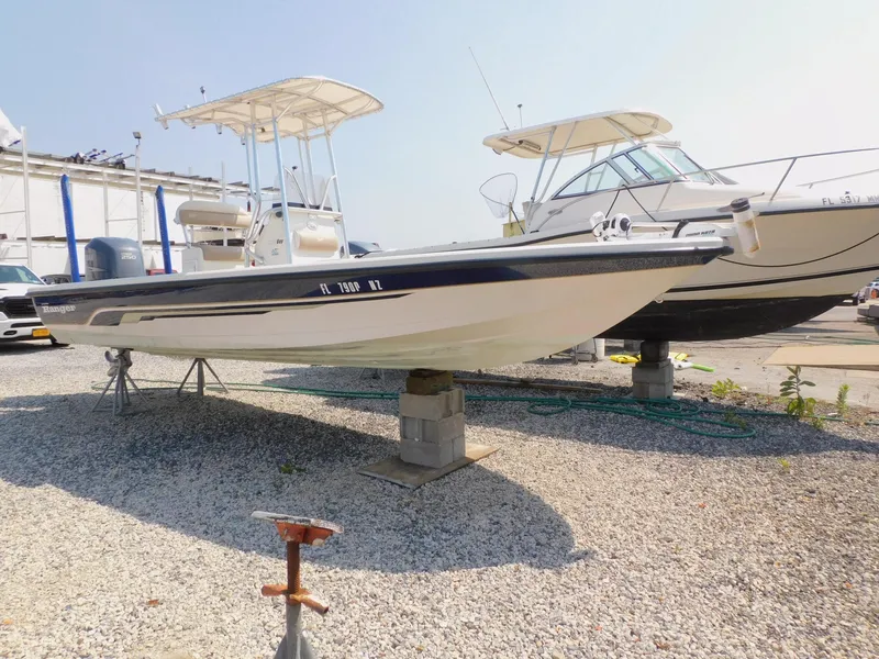 Slide: The Image of 2009 Ranger 2200 Bay Ranger boat on gravel, elevated for maintenance. - 4