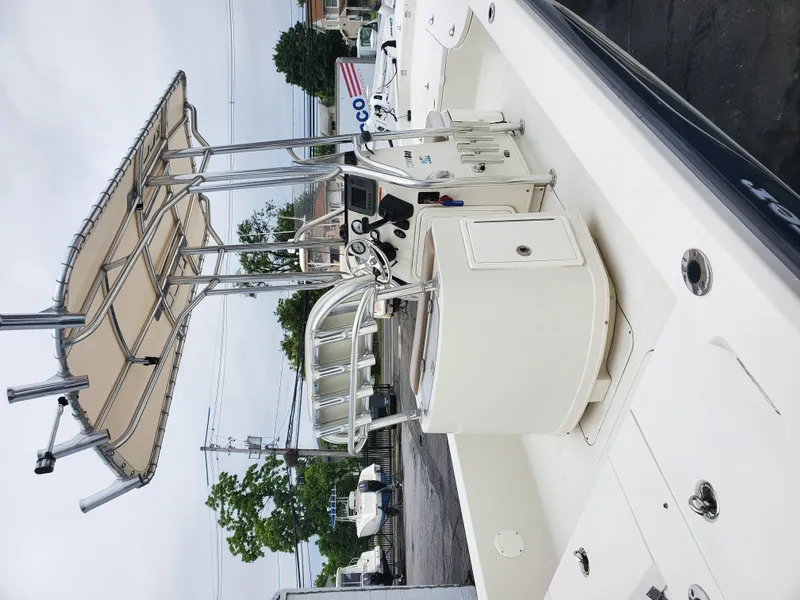 Slide: The Image of 2009 Ranger 2200 Bay Ranger boat with T-top and console, parked outdoors. - 6