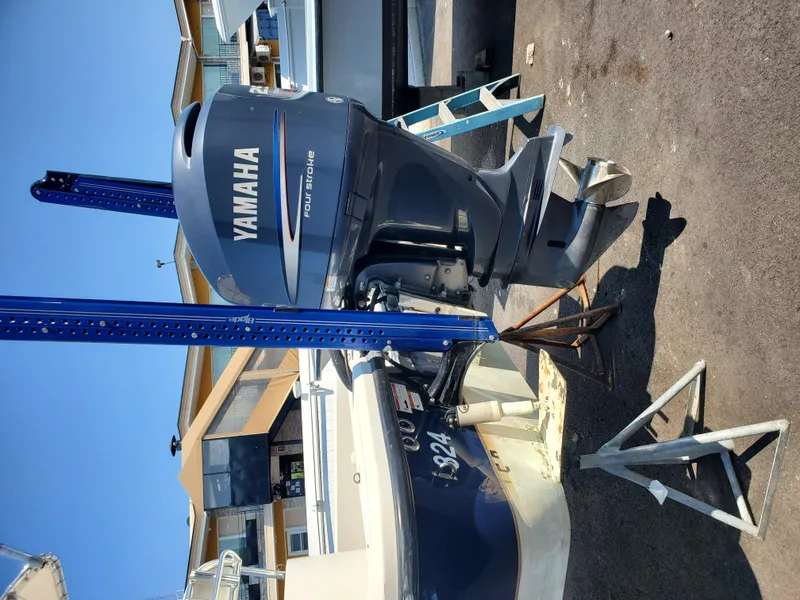 Slide: The Image of 2009 Ranger 2200 Bay Ranger with Yamaha four-stroke outboard motor on a stand. - 8