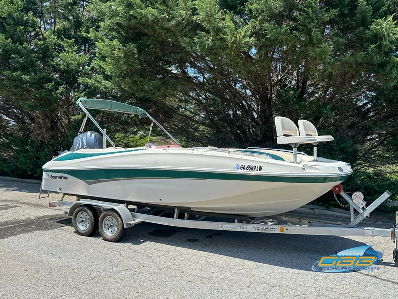 Slide: The Image of 2007 SouthWind 210 SD boat on trailer, parked outdoors with trees in background. - 2
