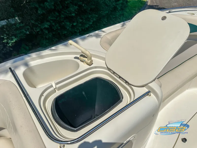 Slide: The Image of 2007 SouthWind 210 SD boat storage compartment with open lid and faucet. - 26