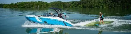 Slide: The Image of 2024 Yamaha AR190 boat towing a wakeboarder on a serene lake. - 10