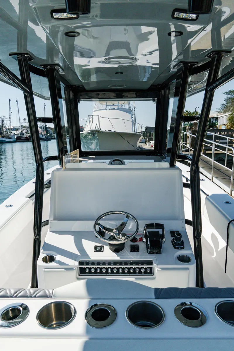 Slide: The Image of 2025 Invincible 36 Open Fisherman boat interior with steering wheel and control panel. - 11