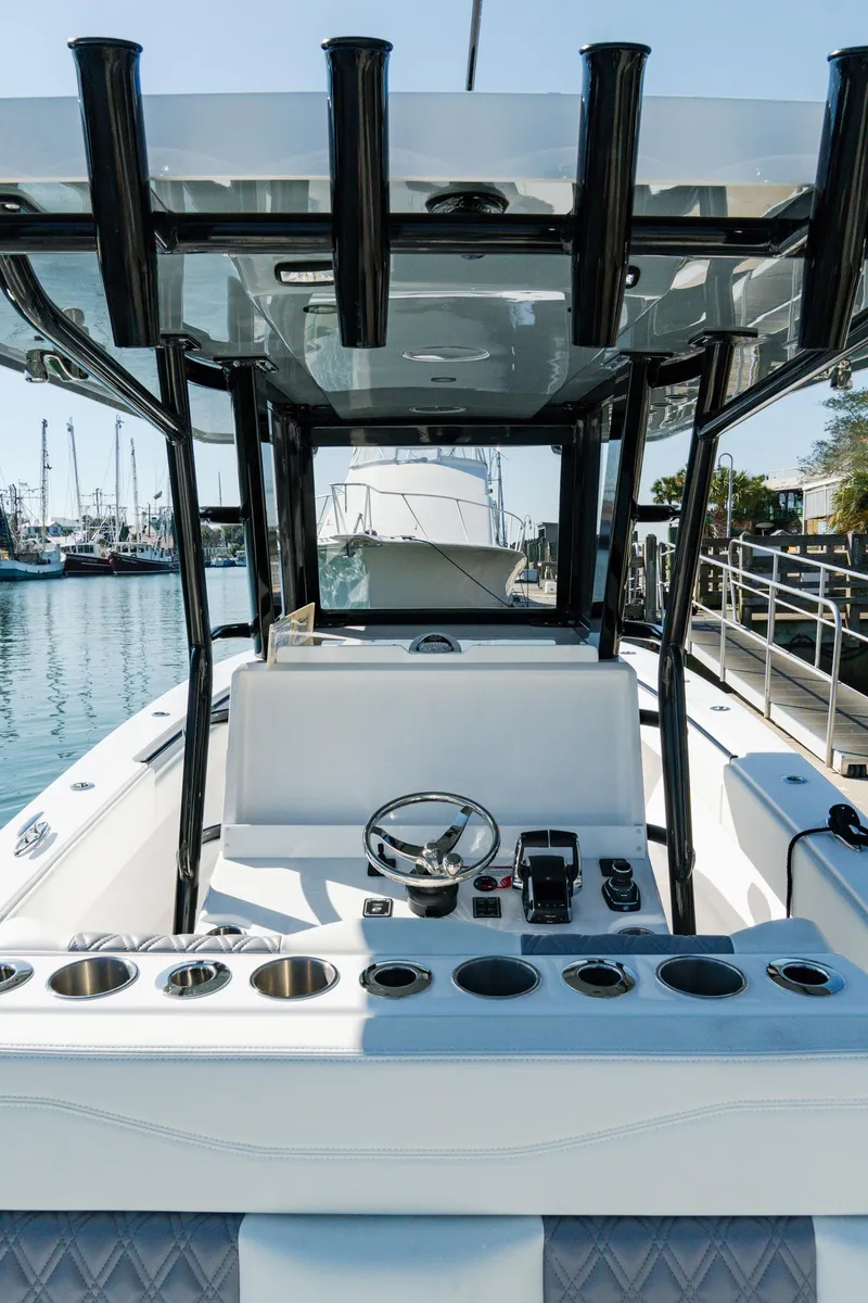 Slide: The Image of 2025 Invincible 36 Open Fisherman boat interior with steering wheel and controls. - 14