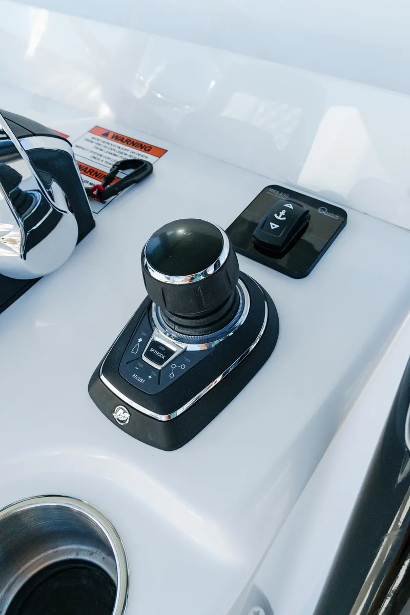 Slide: The Image of 2025 Invincible 36 Open Fisherman boat control panel with joystick and buttons. - 16