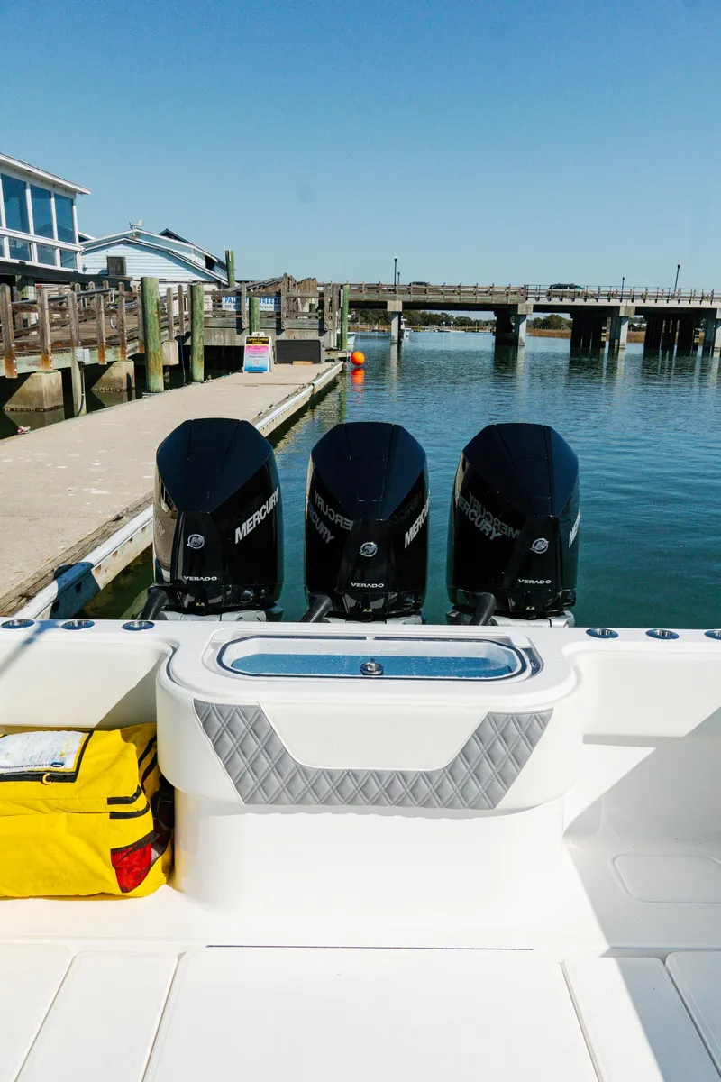 Slide: The Image of 2025 Invincible 36 Open Fisherman boat with triple Mercury engines docked at marina. - 17