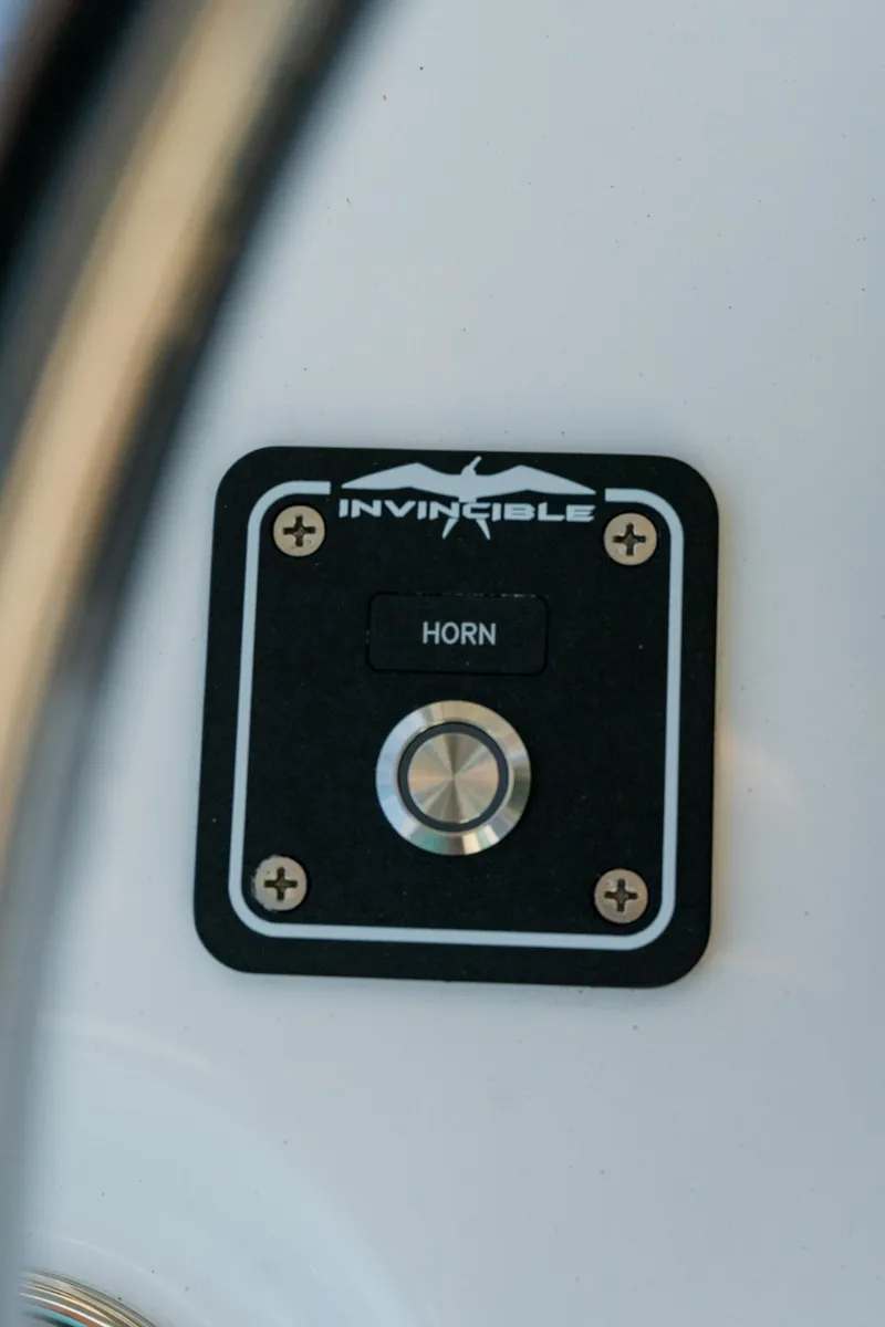 Slide: The Image of Horn button on 2025 Invincible 36 Open Fisherman boat dashboard. - 19