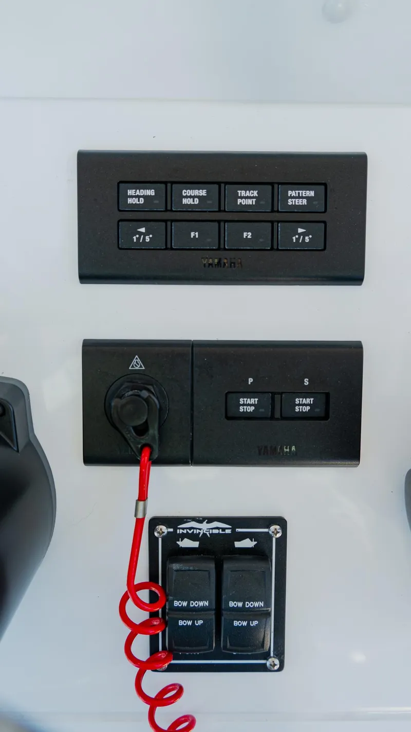 Slide: The Image of Control panel of 2025 Invincible 36 Open Fisherman boat with various switches and buttons. - 20