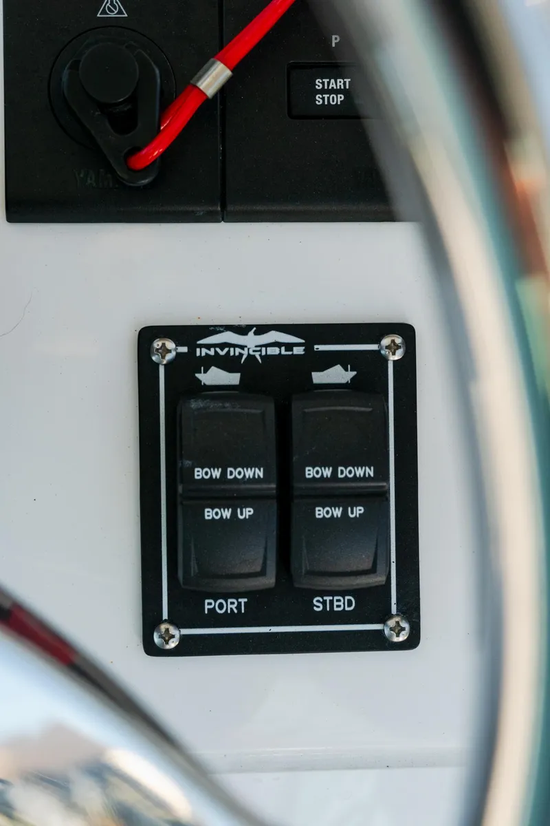 Slide: The Image of Control panel of 2025 Invincible 36 Open Fisherman boat, featuring bow adjustment switches. - 21