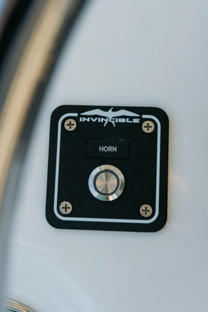 Slide: The Image of Horn button on 2025 Invincible 36 Open Fisherman boat dashboard. - 22