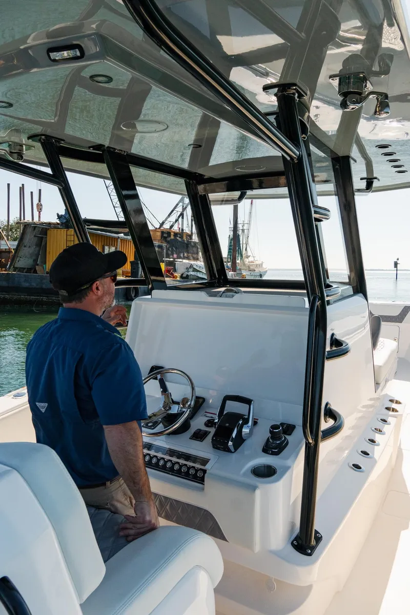 Slide: The Image of 2025 Invincible 36 Open Fisherman boat, featuring modern helm and controls. - 23