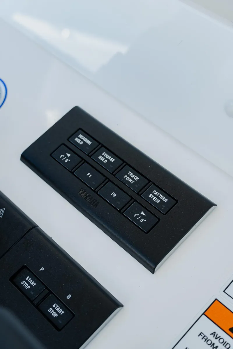 Slide: The Image of Control panel of 2025 Invincible 36 Open Fisherman boat with various function buttons. - 26