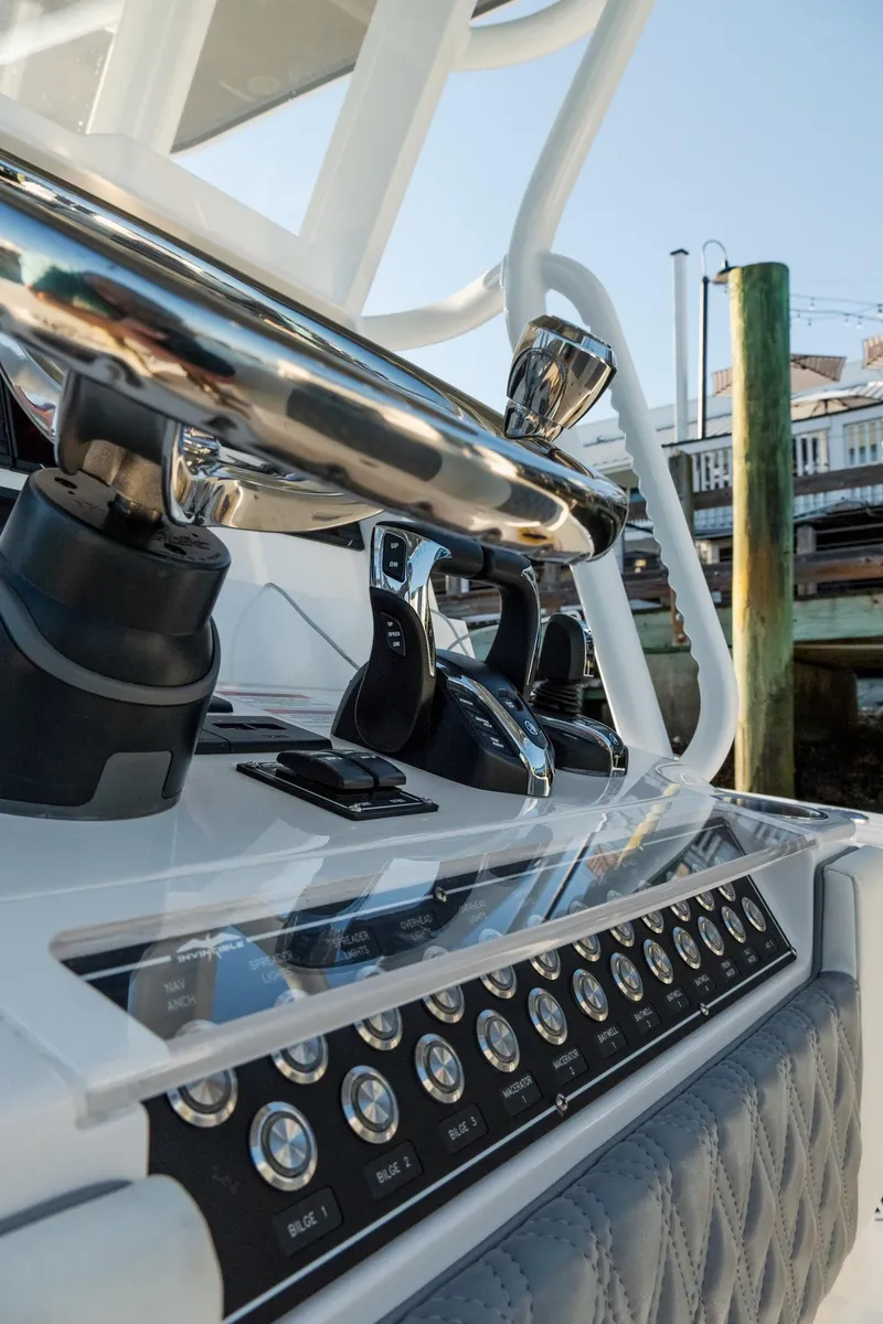 Slide: The Image of 2025 Invincible 36 Open Fisherman boat dashboard with controls and steering wheel. - 28