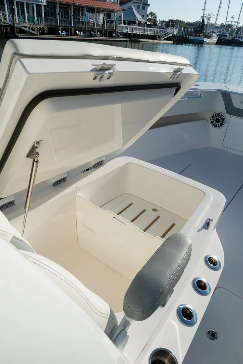 Slide: The Image of 2025 Invincible 36 Open Fisherman boat with open storage compartment, dockside view. - 33