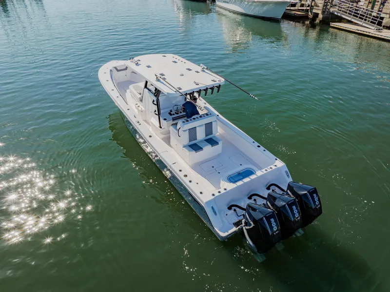 Slide: The Image of 2025 Invincible 36 Open Fisherman boat on water with triple outboard engines. - 36