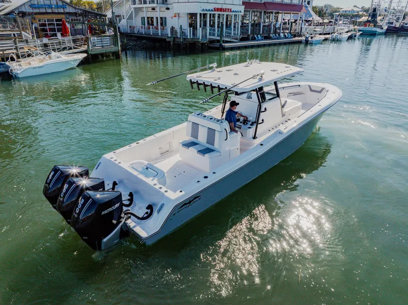 Slide: The Image of 2025 Invincible 36 Open Fisherman boat on water, featuring triple outboard engines. - 38