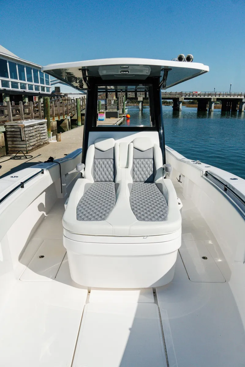 Slide: The Image of 2025 Invincible 36 Open Fisherman boat docked, featuring sleek seating and modern design. - 5