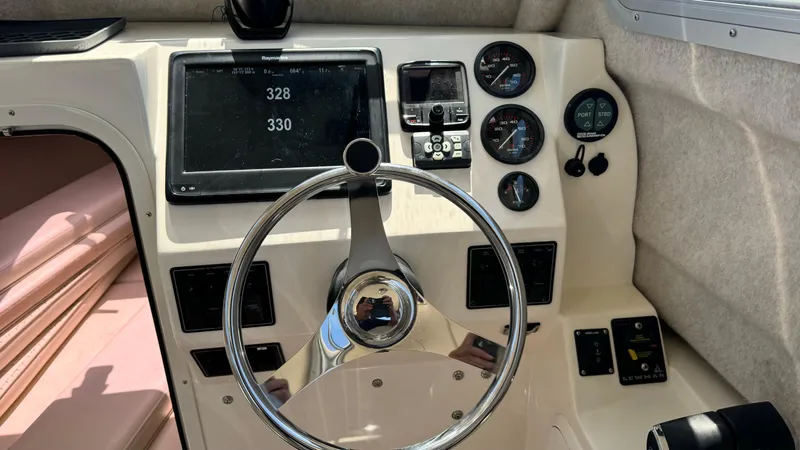 Slide: The Image of 2014 Defiance Guadalupe 290 EX boat dashboard with steering wheel and navigation instruments. - 1