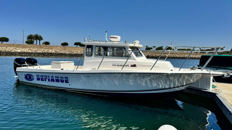 Slide: The Image of 2014 Defiance Guadalupe 290 EX boat docked in sunny marina. - 11