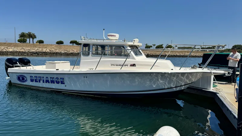 Slide: The Image of 2014 Defiance Guadalupe 290 EX boat docked in sunny marina. - 12