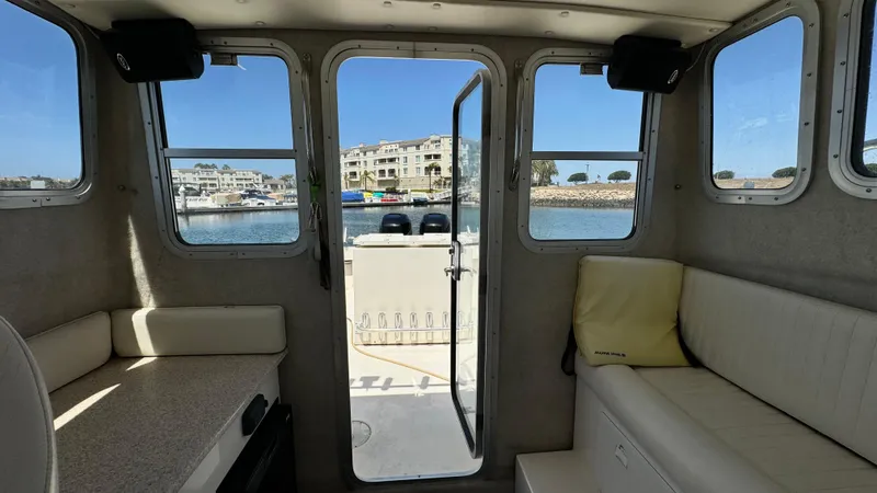 Slide: The Image of Interior view of 2014 Defiance Guadalupe 290 EX boat with waterfront background. - 18