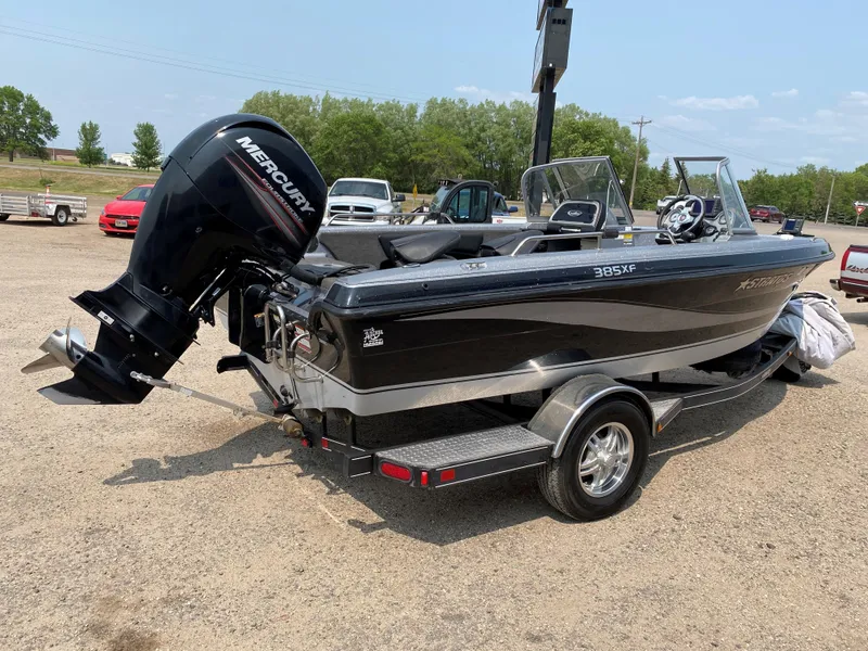 Slide: The Image of 2013 Stratos 385 XF boat with Mercury outboard motor on a trailer. - 10