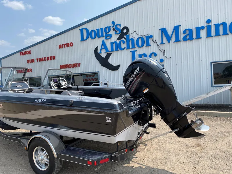 Slide: The Image of 2013 Stratos 385 XF boat at Doug's Anchor Marine, featuring a Mercury outboard motor. - 11