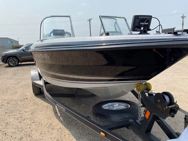 Slide: The Image of 2013 Stratos 385 XF boat on trailer, black exterior, parked outdoors. - 6