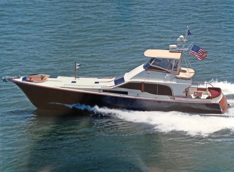 The Image of 1986 Midnight Lace 52 Flybridge yacht cruising on open water, American flag waving. - 0