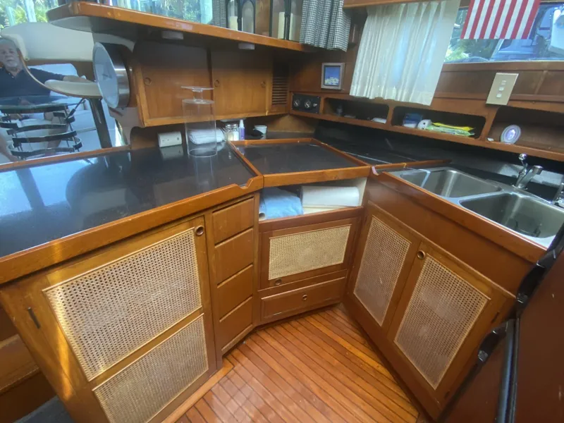 Slide: The Image of 1986 Midnight Lace 52 Flybridge yacht kitchen with wood cabinetry and dual sinks. - 16