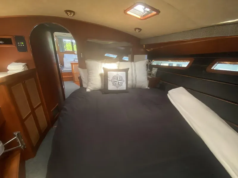 Slide: The Image of Luxurious cabin interior of 1986 Midnight Lace 52 Flybridge yacht with cozy bedding. - 19