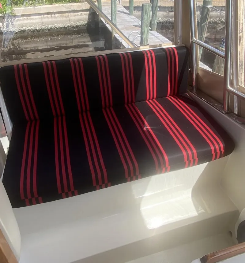 Slide: The Image of Striped seating on 1986 Midnight Lace 52 Flybridge yacht, featuring red and black upholstery. - 25