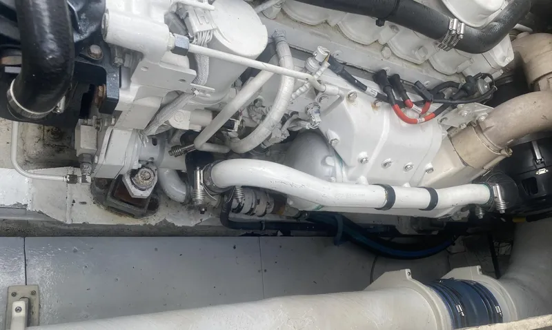 Slide: The Image of Engine compartment of a 1986 Midnight Lace 52 Flybridge yacht, showcasing mechanical components. - 29