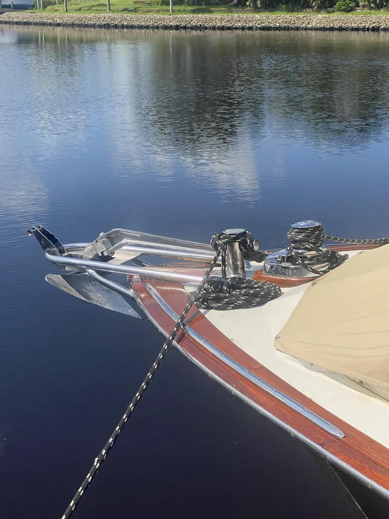 Slide: The Image of 1986 Midnight Lace 52 Flybridge yacht anchored on calm water. - 3