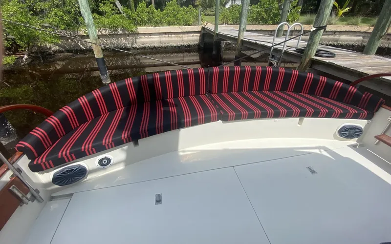 Slide: The Image of Red and black striped seating on 1986 Midnight Lace 52 Flybridge boat deck. - 5